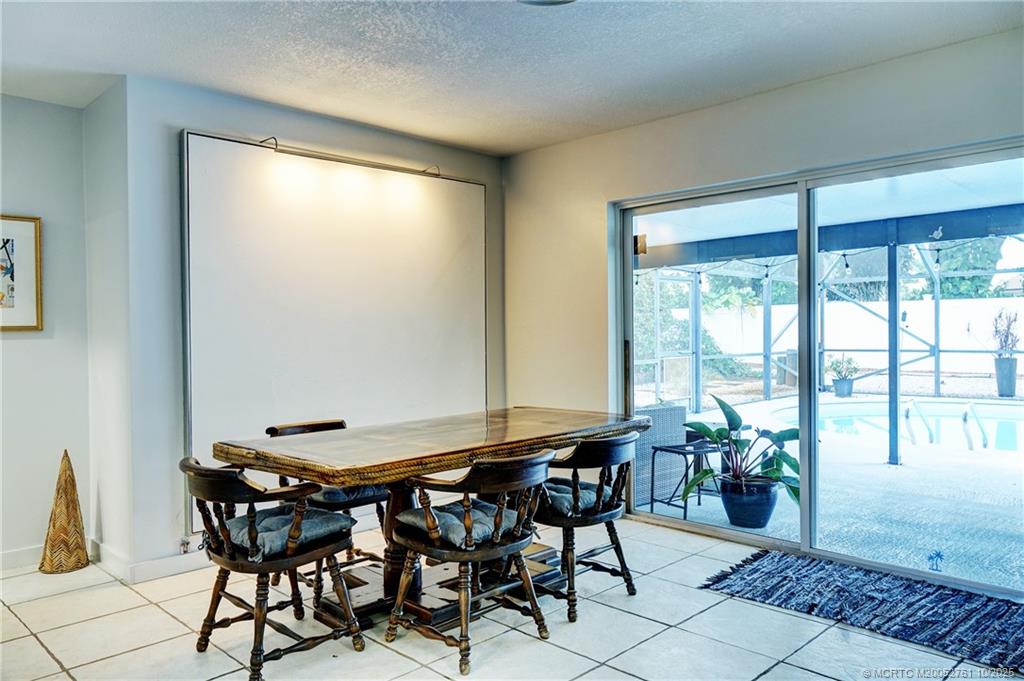 905 Southeast Flamingo Avenue Stuart, FL 34996 - Photo 10 of 36 a view of a dining room with furniture and a window