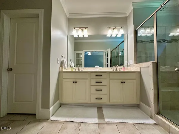 a bathroom with a double vanity sink and a mirror
