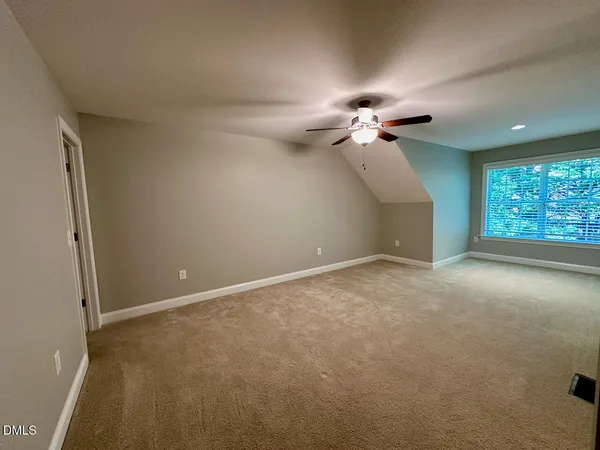 a view of a livingroom with a ceiling fan and window