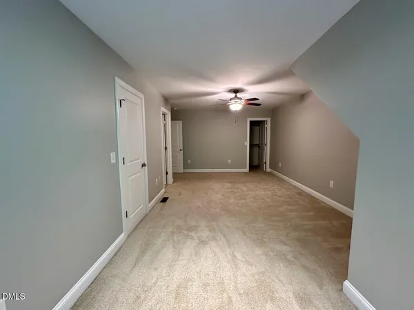 a view of a hallway with chandelier