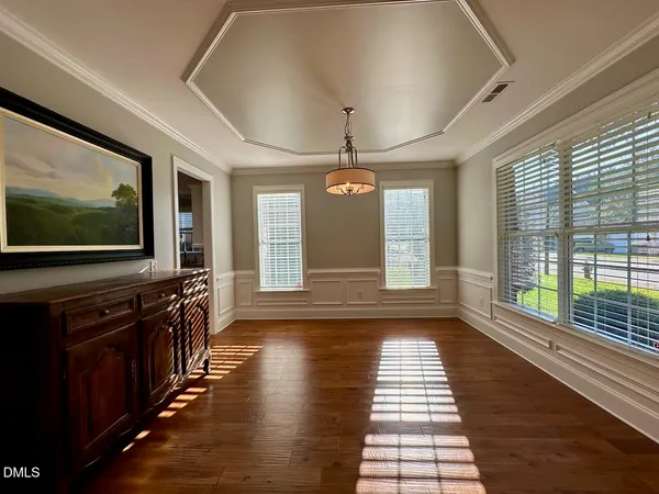 a view of a room with wooden floor and windows