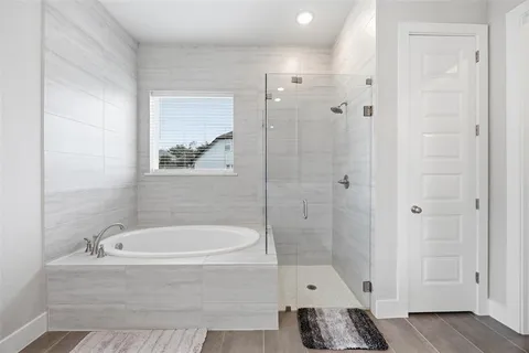 a bathroom with a tub and a shower