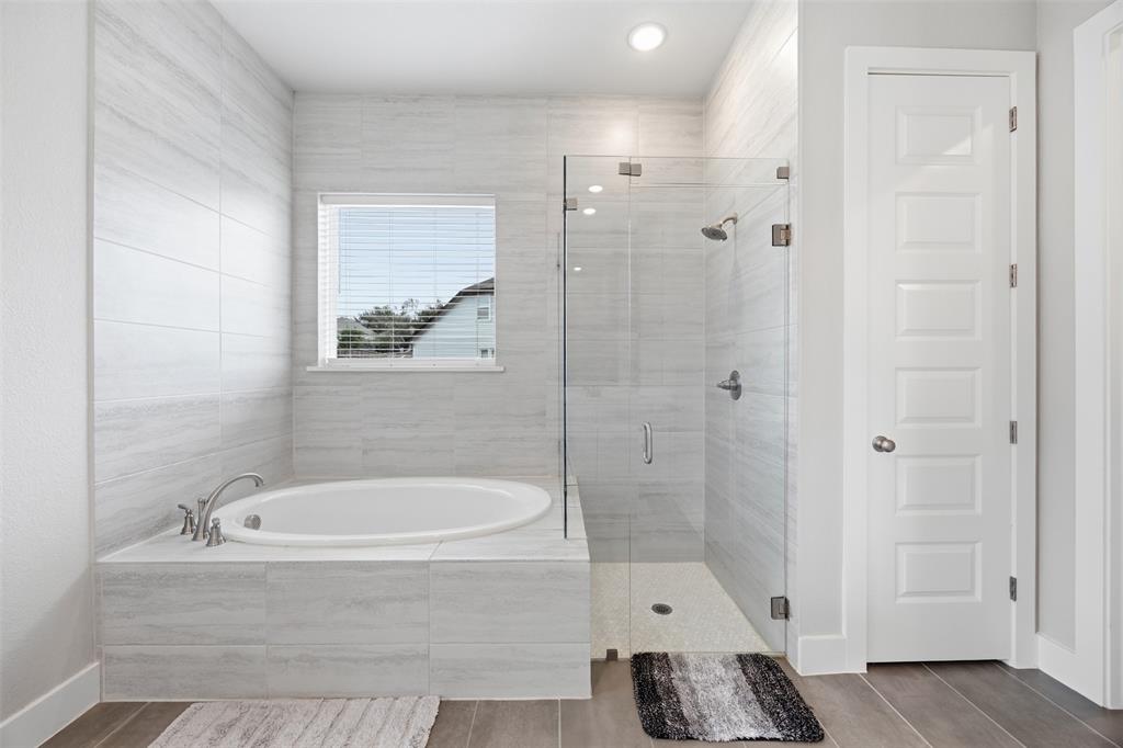 5805 Heatherwood Loop Sachse, TX 75048 - Photo 25 of 39 a bathroom with a tub and a shower