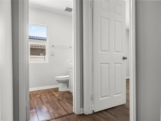 a bathroom with a sink toilet and a mirror