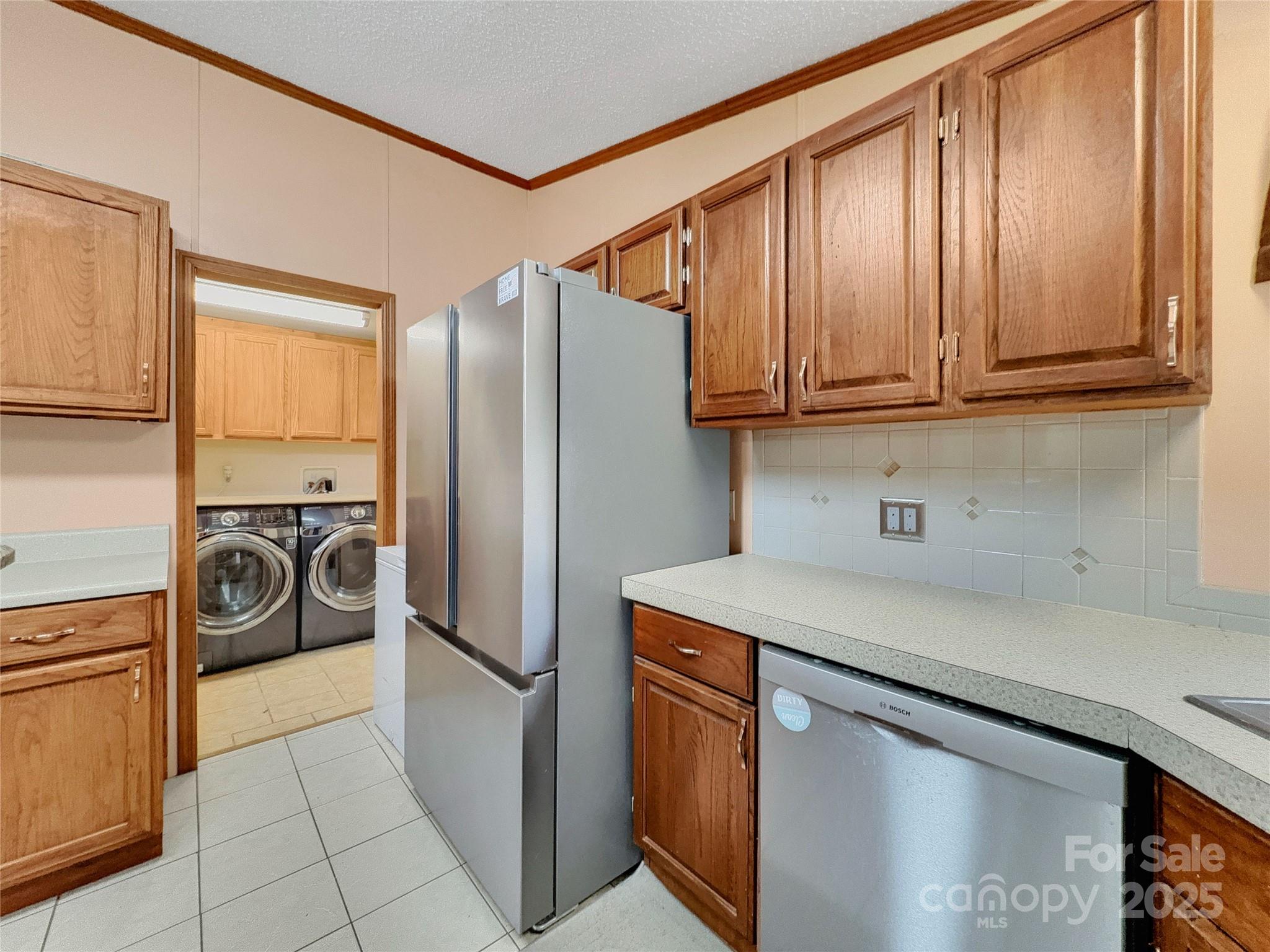 3215 Shadybark Trail Catawba, SC 29704 - Photo 14 of 36 a kitchen with refrigerator a washer and dryer