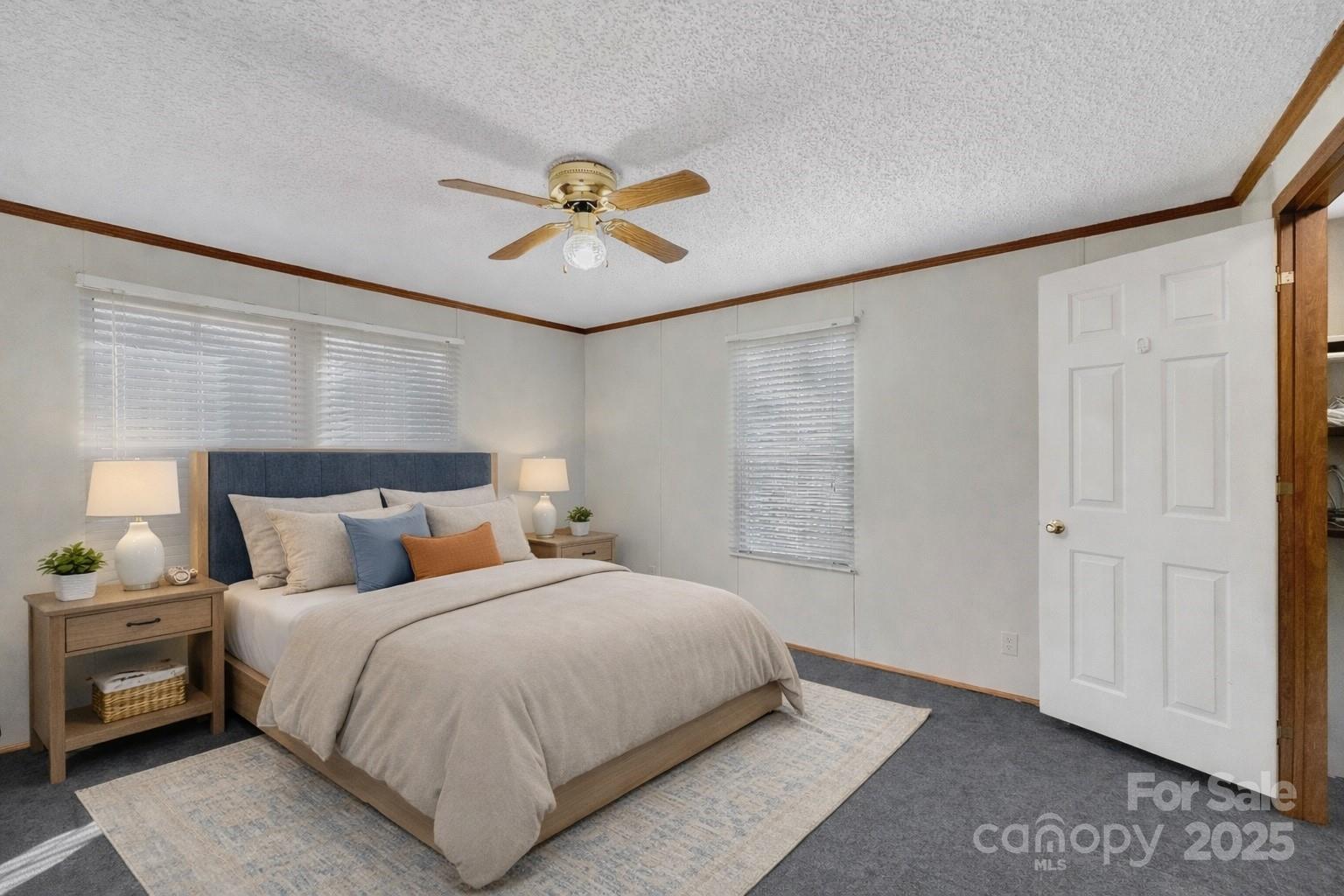 3215 Shadybark Trail Catawba, SC 29704 - Photo 21 of 36 a bedroom with a large bed and a chandelier