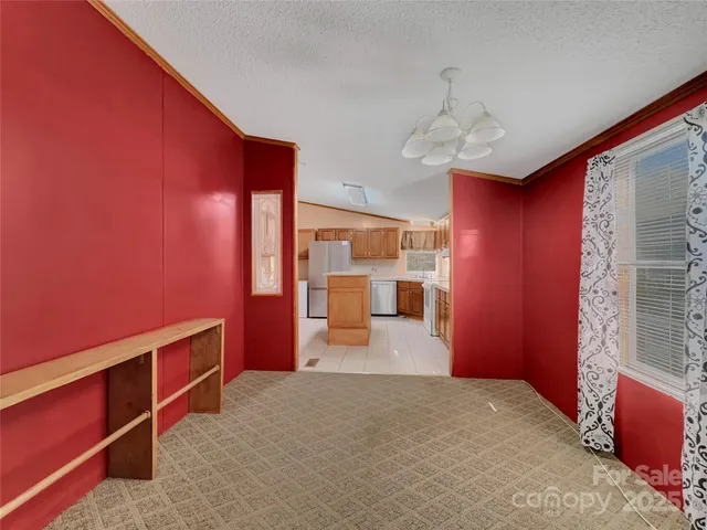 a kitchen with stainless steel appliances granite countertop a sink counter space cabinets and a large window