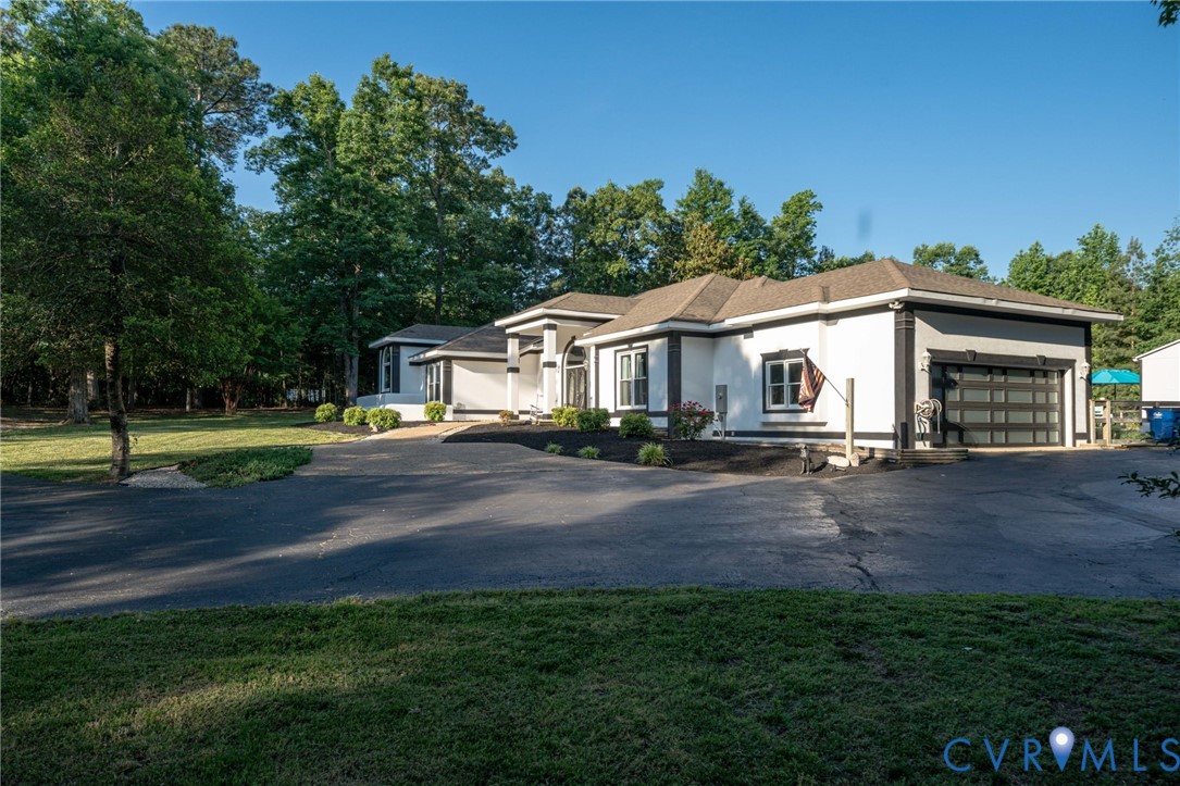 12700 Coalboro Road Chesterfield, VA 23838 - Photo 5 of 50 White stucco exterior with dark trim accents and a