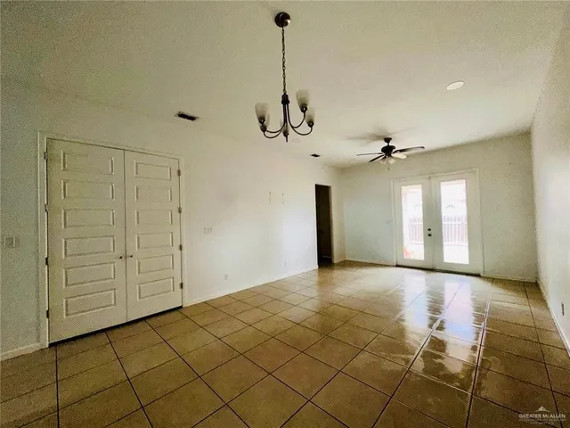 a kitchen with a sink a refrigerator and white cabinets