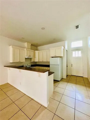 a kitchen with stainless steel appliances a refrigerator sink and cabinets