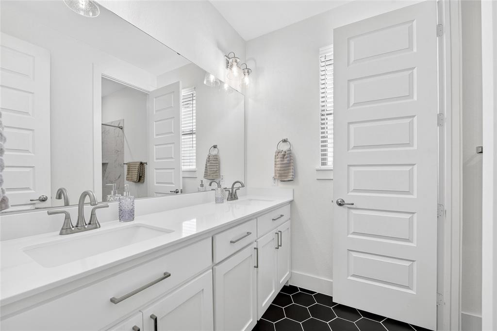 209 Basalt Lane Azle, TX 76020 - Photo 11 of 39 a bathroom with a double vanity sink a mirror and a shower
