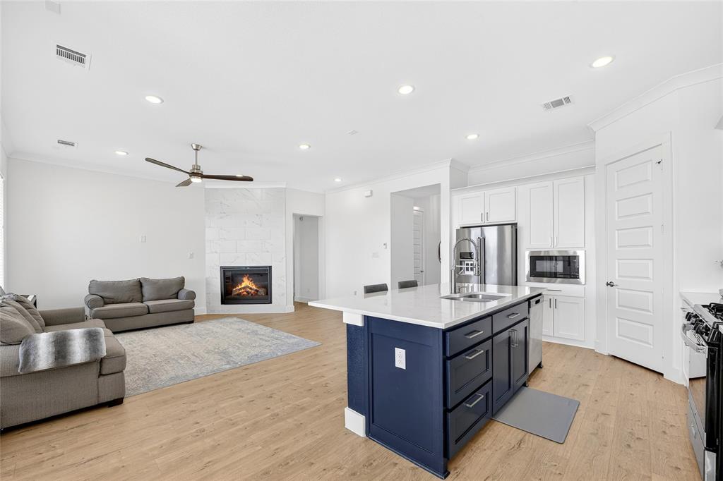 209 Basalt Lane Azle, TX 76020 - Photo 20 of 39 a living room with stainless steel appliances kitchen island granite countertop a couch and a view of kitchen