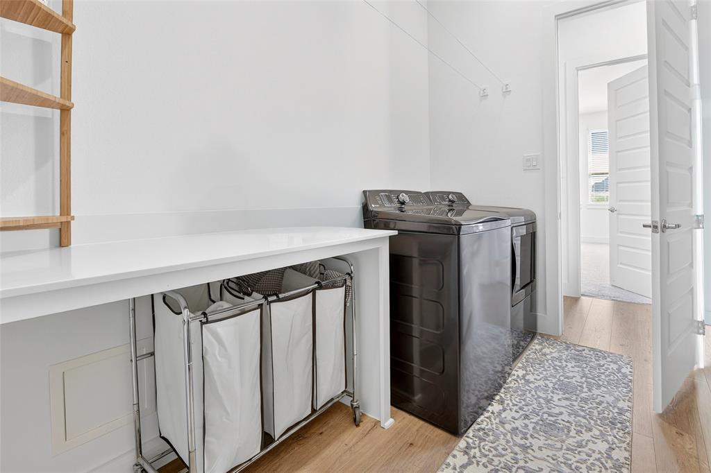 209 Basalt Lane Azle, TX 76020 - Photo 25 of 39 a view of walk in closet with rug and wooden floor