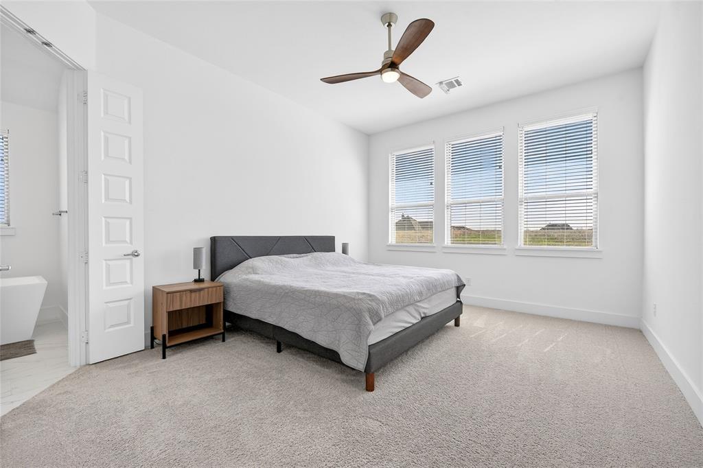209 Basalt Lane Azle, TX 76020 - Photo 26 of 39 a bedroom with a bed and a large window