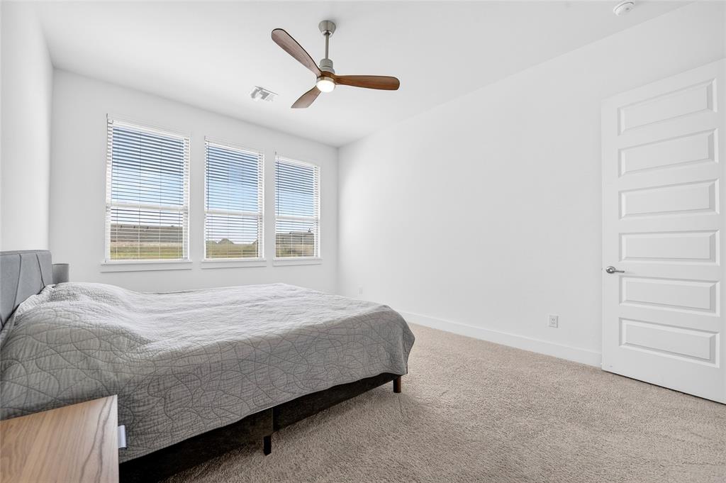 209 Basalt Lane Azle, TX 76020 - Photo 28 of 39 a bed sitting in a bedroom next to a window