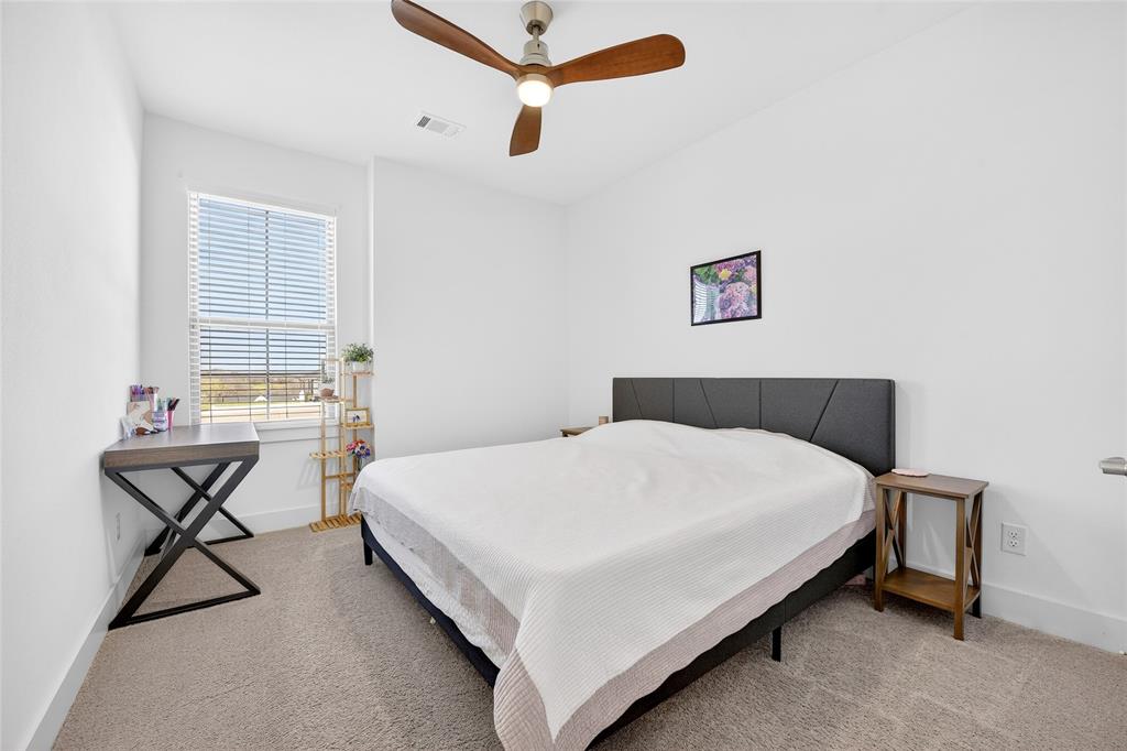 209 Basalt Lane Azle, TX 76020 - Photo 9 of 39 a bedroom with a bed and table chair