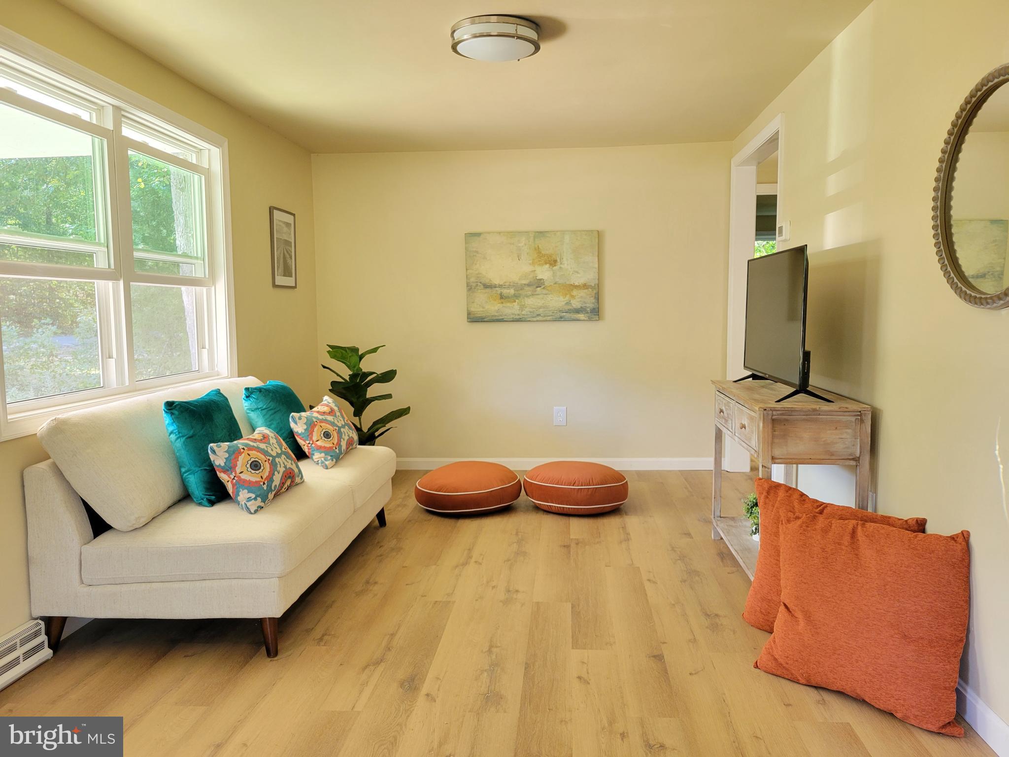 201 Grainery Road Montross, VA 22520 - Photo 2 of 9 a living room with furniture and a flat screen tv