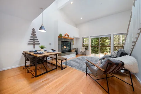 a living room with furniture and kitchen view