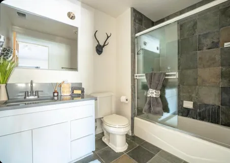 a living room with furniture and a lamp