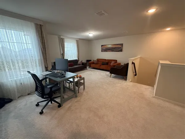 a living room with furniture and a rug