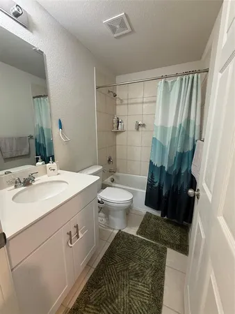 a spacious bathroom with a double vanity sink toilet and shower