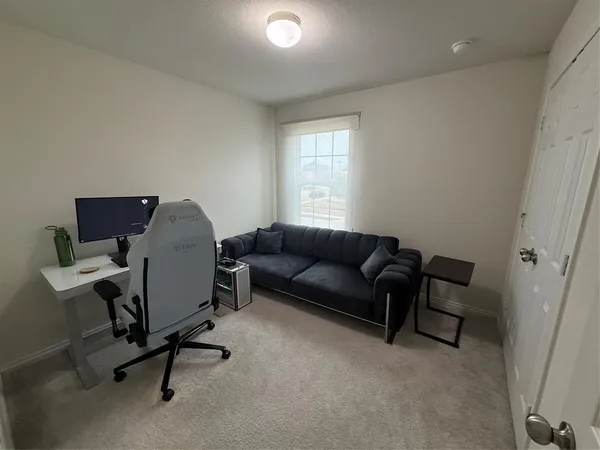 a livingroom with workspace and a couch