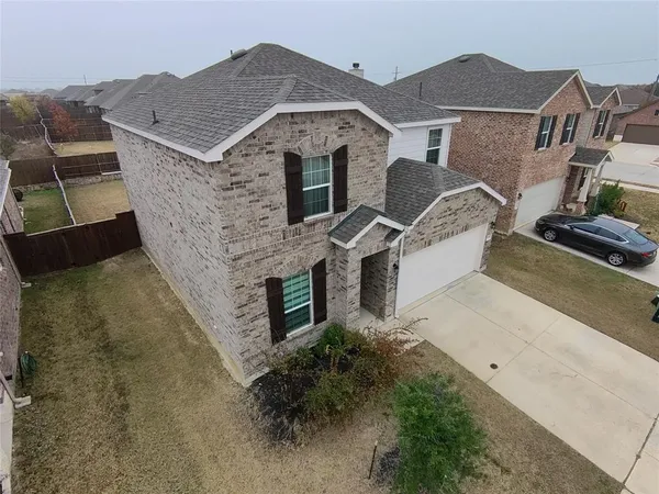 an aerial view of a house with a yard