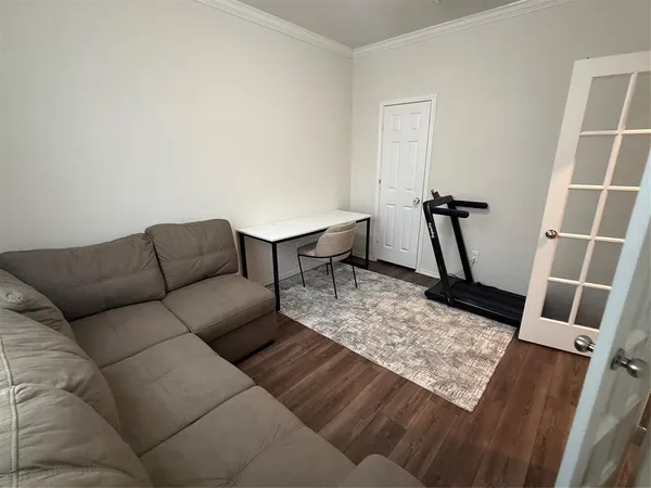 a living room with furniture and a wooden floor