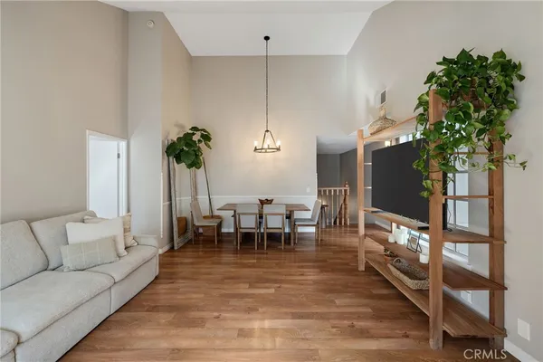 a living room with furniture a potted plant and a table