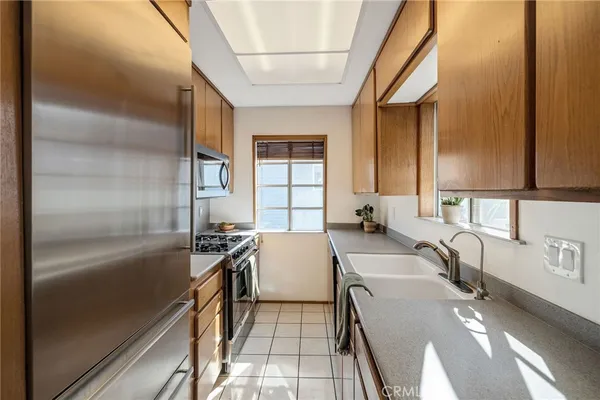 a kitchen with a sink appliances and cabinets