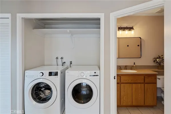 a utility room with sink dryer and washer