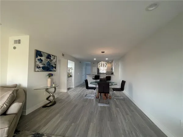 a view of a livingroom with furniture and wooden floor