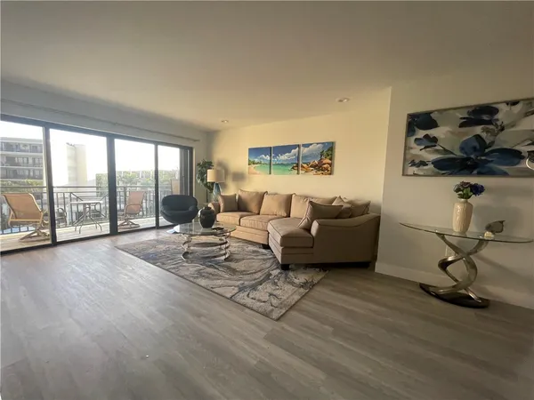 a living room with furniture window and wooden floor