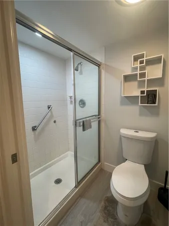 a bathroom with a toilet and a shower