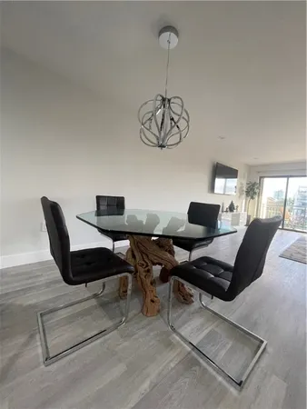 a work room with furniture rug and a window