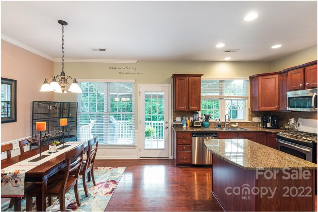 1132 Drayton Court, Unit 130 Fort Mill, SC 29708 - Photo 11 of 24 a view of a dining room and livingroom with furniture wooden floor a chandelier
