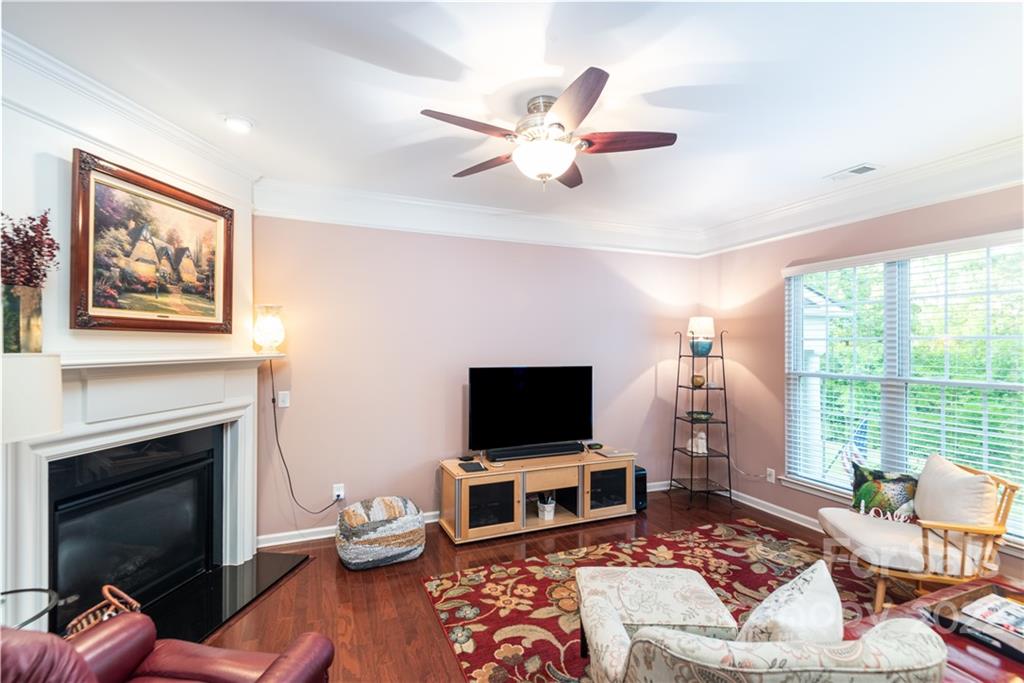 1132 Drayton Court, Unit 130 Fort Mill, SC 29708 - Photo 5 of 24 a living room with furniture a flat screen tv and a fireplace
