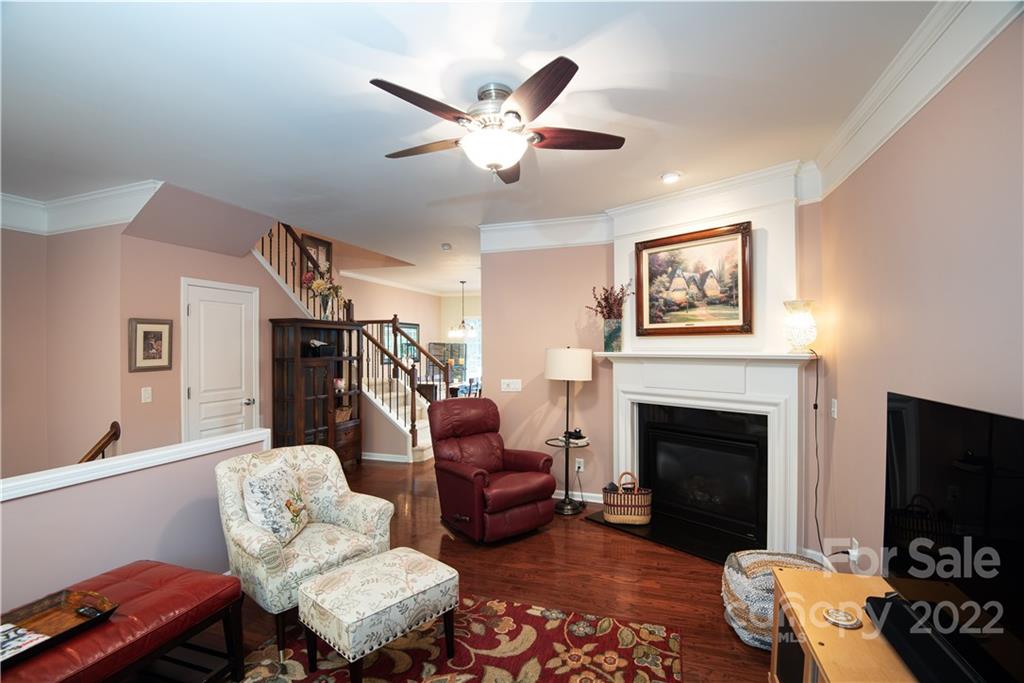 1132 Drayton Court, Unit 130 Fort Mill, SC 29708 - Photo 6 of 24 a living room with furniture a flat screen tv and a fireplace