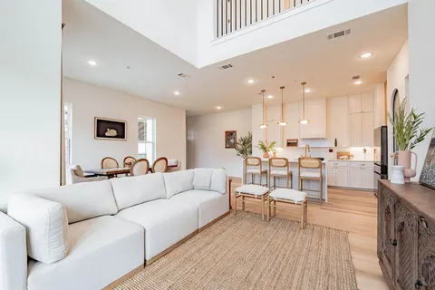 a view of a living room kitchen with a table and chairs