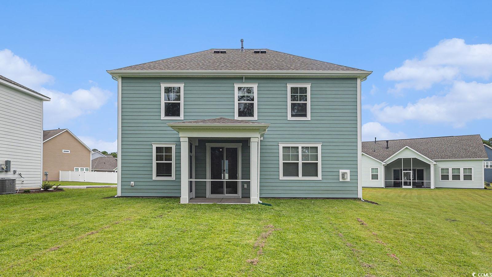 728 Doonbeg Court Conway, SC 29526 - Photo 2 of 4 Back of property featuring a yard, a sunroom, and roof with shingles