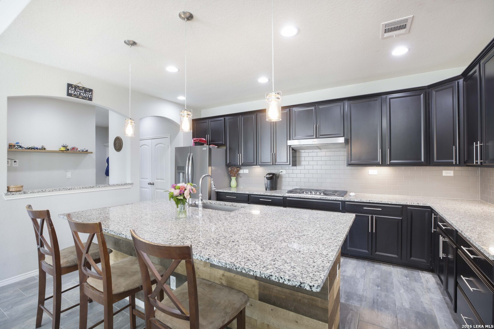 11638 Chalk Stem Schertz, TX 78154 - Photo 11 of 37 a kitchen with stainless steel appliances granite countertop a table chairs sink refrigerator and cabinets