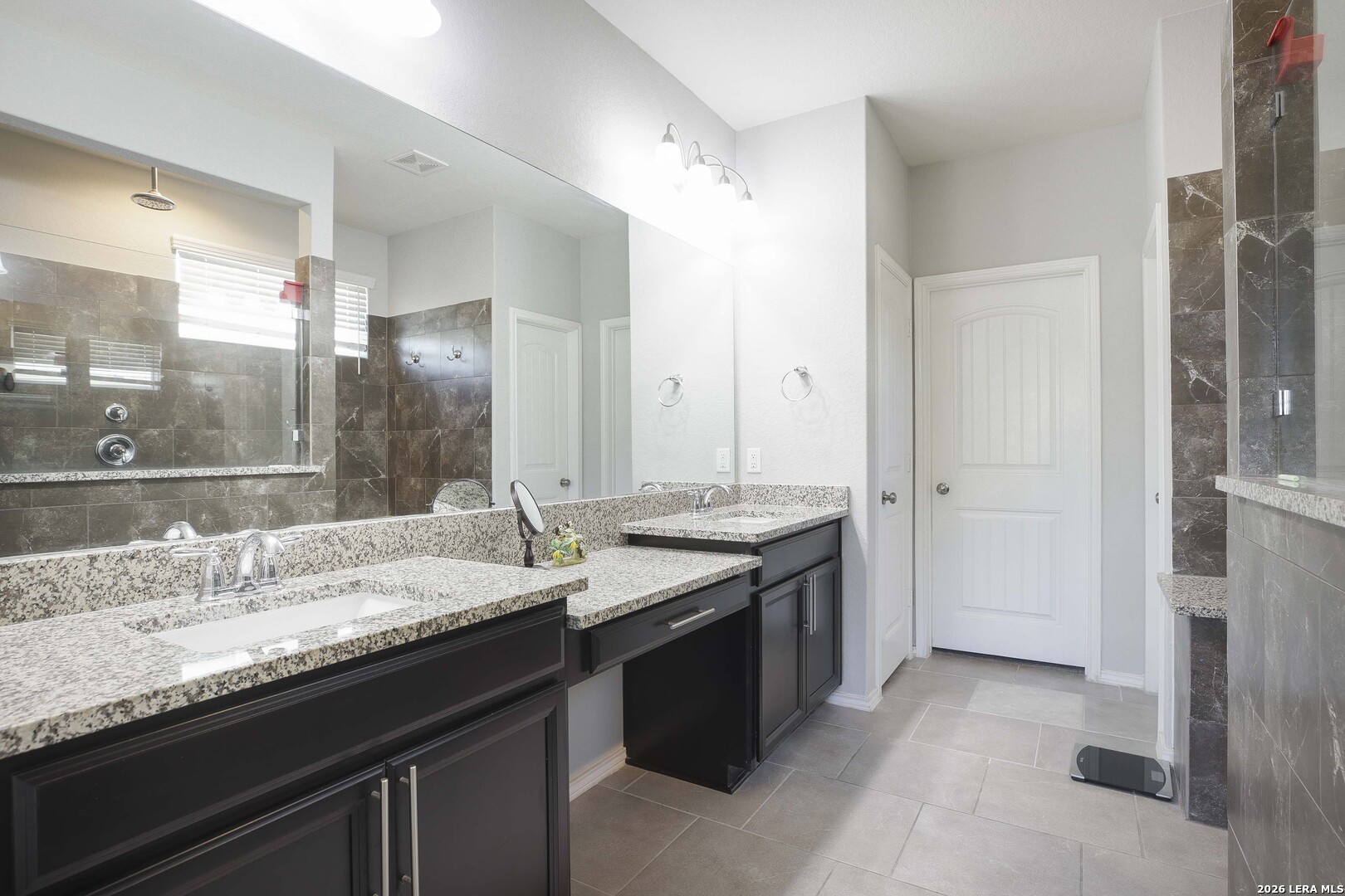 11638 Chalk Stem Schertz, TX 78154 - Photo 24 of 37 a bathroom with a granite countertop sink a large mirror and a shower