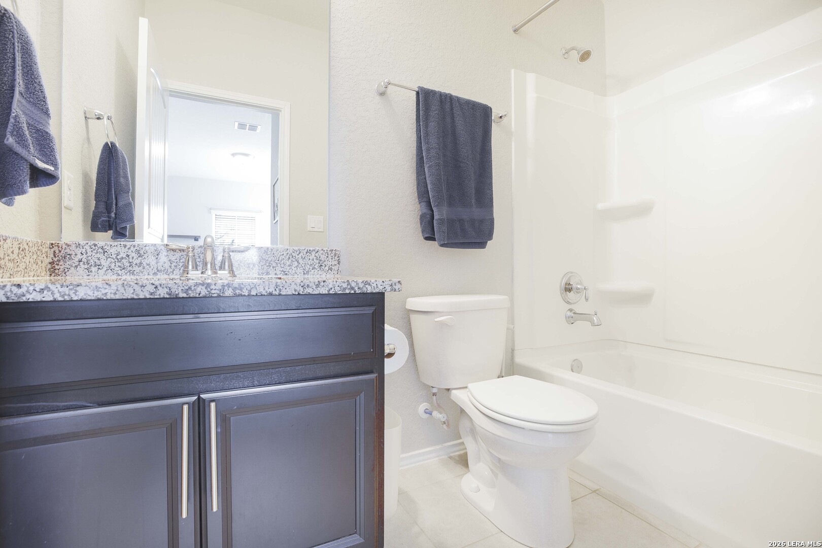 11638 Chalk Stem Schertz, TX 78154 - Photo 31 of 37 a bathroom with a granite countertop toilet sink and mirror