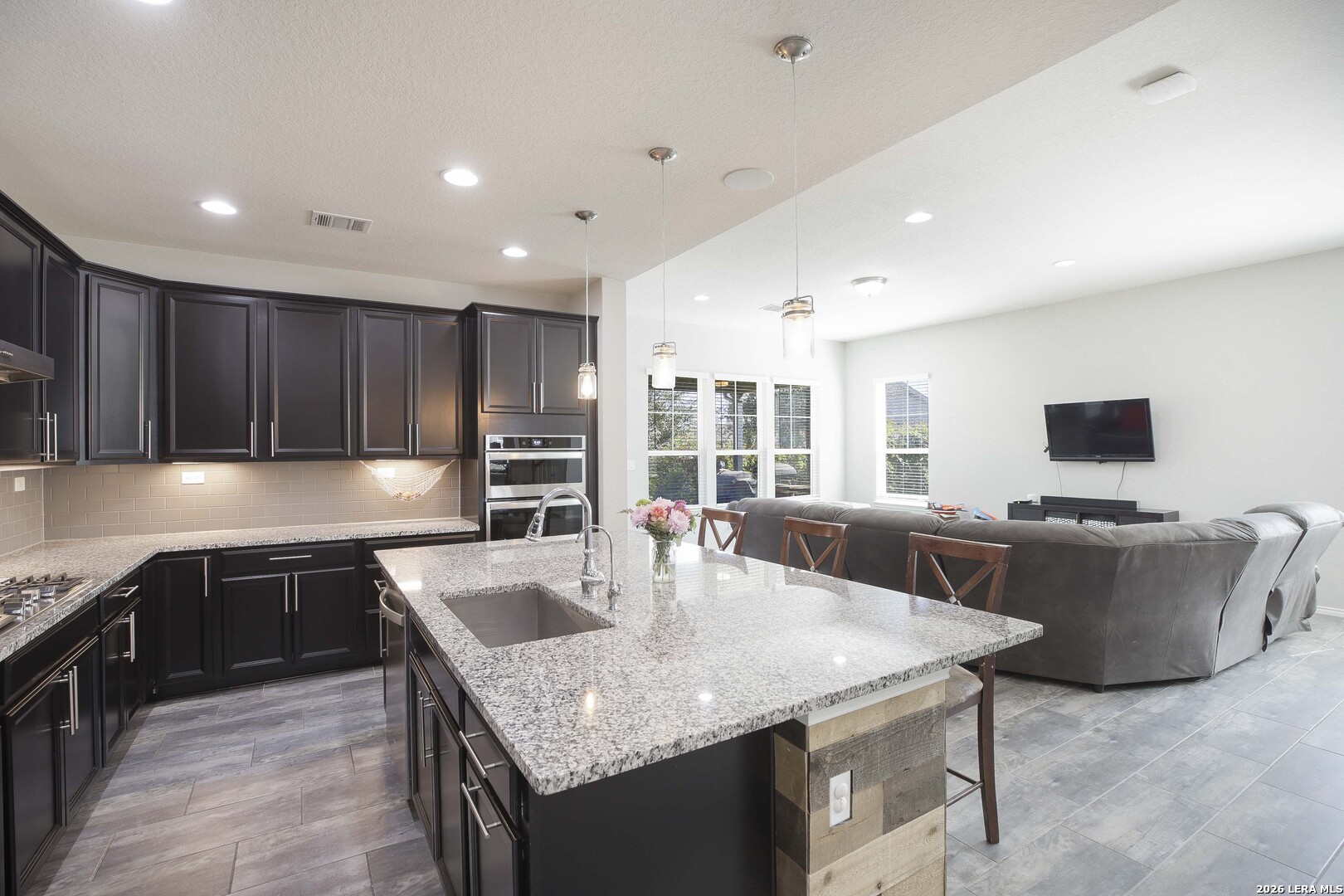 11638 Chalk Stem Schertz, TX 78154 - Photo 10 of 37 a kitchen with stainless steel appliances granite countertop a sink and a refrigerator