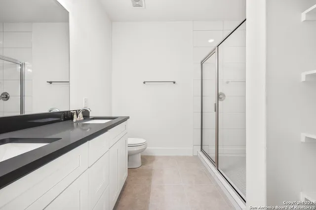 a bathroom with a granite countertop sink a toilet and bathtub