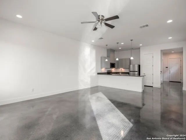 a view of a kitchen with a sink and a stove top oven
