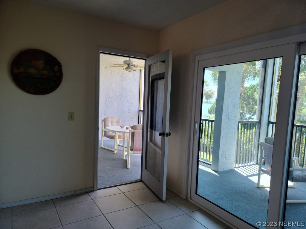 6544 Engram Road, Unit E203 New Smyrna Beach, FL 32169 - Photo 14 of 27 a view of living room and front door
