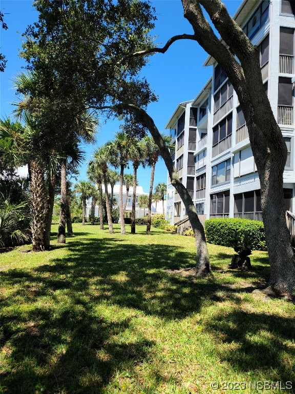 6544 Engram Road, Unit E203 New Smyrna Beach, FL 32169 - Photo 2 of 27 a view of a house with a yard