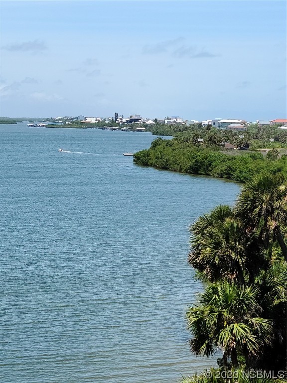 6544 Engram Road, Unit E203 New Smyrna Beach, FL 32169 - Photo 3 of 27 a view of a lake with houses in the back
