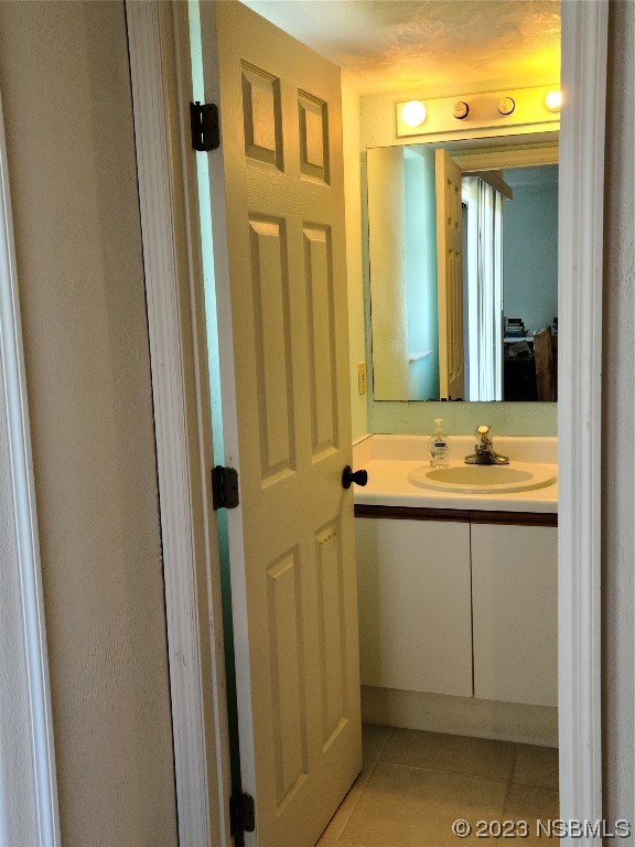 6544 Engram Road, Unit E203 New Smyrna Beach, FL 32169 - Photo 10 of 27 a bathroom with a sink a mirror and a shower